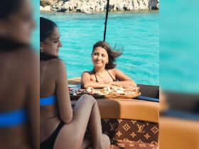 Two friends enjoy a relaxing moment on a boat, sharing delicious snacks while surrounded by stunning turquoise waters — perfect for a day of fun and friendship on the water.