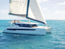 A sleek catamaran sails gracefully through turquoise waters, showcasing its elegant design and perfect for a day of adventure on the sea.