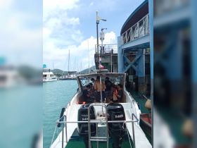 A lively group prepares for their boating adventure at the dock, showcasing the excitement of a day on the water.