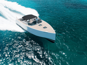 A sleek speedboat glides through crystal-clear waters, showcasing its modern design and performance — perfect for thrilling adventures on the open sea.