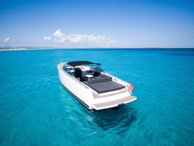 A stunning aerial view of a sleek speedboat cruising through crystal-clear turquoise waters, perfect for luxury outings and island adventures.