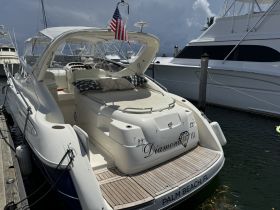 A sleek yacht named 'Diamond III' docked in Palm Beach, showcasing its elegant design and inviting deck space.