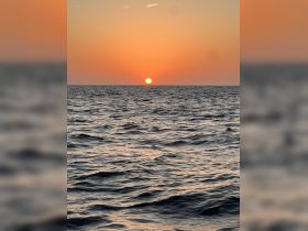 A stunning sunset over the ocean, casting vibrant colors across the sky and water — a perfect moment for relaxation and reflection on a boating adventure.