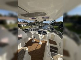 The interior helm of a boat showcases modern seating and navigation equipment, perfect for steering through scenic waterways.
