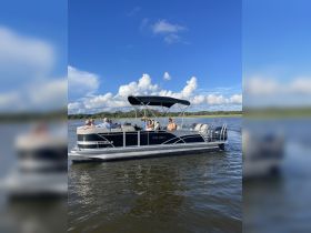 A lively group enjoys a day on a Sylvan pontoon boat, perfect for socializing and exploring the waterways.