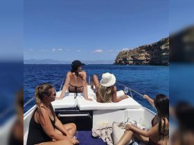 A group of friends relaxes on a boat, enjoying the sun and ocean views — perfect for a day of celebration and leisure on the water.