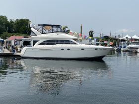 A sleek yacht named 'Ocean Breeze' docked at the marina, showcasing its elegant design and inviting atmosphere for potential renters.