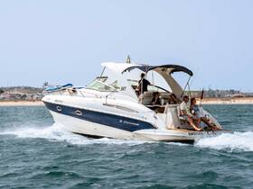 A lively group enjoys a day on the water aboard a sleek boat, capturing the essence of summer fun with friends and beautiful beach views.