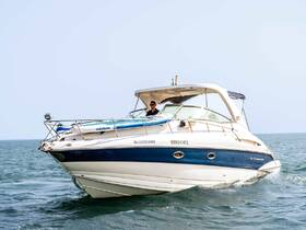 A sleek speedboat named 'Blueberry' glides through the water with a captain at the helm, showcasing the thrill of boating adventures.