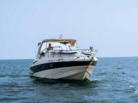 A yacht named 'Blueberry' navigates the open waters with a captain at the helm, showcasing the thrill of boating adventures.