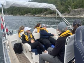 A group of guests enjoys a scenic boat ride, showcasing the camaraderie and adventure of exploring the waters together.
