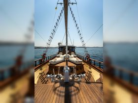 A stunning view of the bow of a yacht, showcasing its elegant design and wooden deck, perfect for enjoying a day on the water.