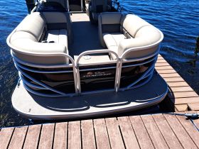 Interior view of a spacious pontoon boat featuring comfortable seating, perfect for relaxing on the water.