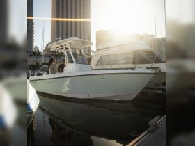 A group of friends enjoys their time aboard a boat at the dock during sunset, capturing the essence of a perfect day on the water.