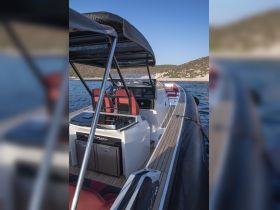 Interior view of a sleek boat helm featuring comfortable seating and modern controls, ideal for navigating the open waters.