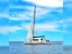 A beautiful sailboat glides through calm waters under a clear blue sky, showcasing the perfect setting for a day of sailing adventures.