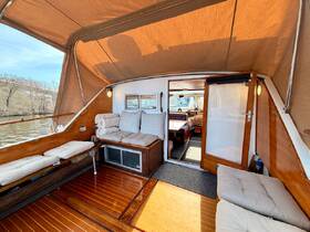 A cozy interior view of a boat's lounge area featuring comfortable seating and a welcoming atmosphere, perfect for relaxing during a day on the water.