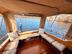 Cozy interior view of a boat's lounge area featuring comfortable seating and a serene water backdrop, perfect for relaxing on the water.