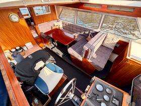 Interior view of a cozy boat cabin featuring comfortable seating and a well-equipped helm, perfect for relaxing or navigating on the water.