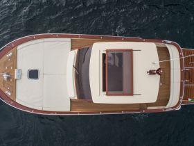 Aerial view of a beautifully designed boat showcasing its sleek lines and elegant features, perfect for luxury cruising on the water.