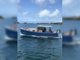 A vibrant group enjoys a day on the water aboard a charming blue boat, showcasing the perfect setting for a fun-filled boating experience.