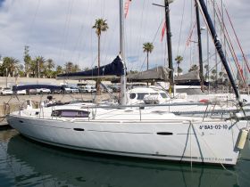 A sleek Beneteau yacht docked in a marina, showcasing its elegant design and ready for sailing adventures.