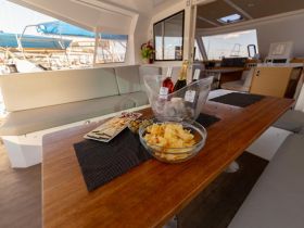 A beautifully arranged table on a boat featuring snacks and drinks, perfect for enjoying a relaxing day on the water.