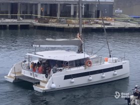 A lively group enjoys a celebration aboard a catamaran, showcasing the perfect setting for fun and socializing on the water.
