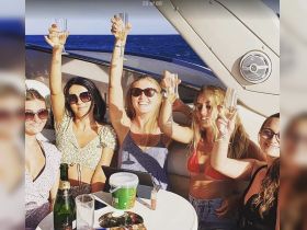 A group of friends raises their glasses in celebration aboard a yacht, enjoying a sunny day on the water — perfect for memorable gatherings and parties.