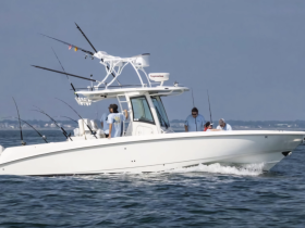 A group of friends enjoys a fishing trip aboard a sleek boat, showcasing the excitement of on-water activities and camaraderie.