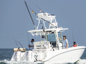 A group of anglers aboard a fishing boat enjoy their time on the water, showcasing the excitement of fishing adventures.