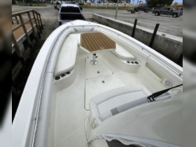 Interior view of a boat's helm and seating area, showcasing a clean and spacious design perfect for comfortable cruising.
