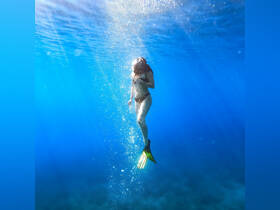 A snorkeler explores the vibrant underwater world, surrounded by clear blue waters — a perfect moment for adventure seekers and marine enthusiasts.