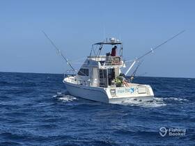 A fishing boat named 'Fish On' is actively engaged in fishing on the open ocean, showcasing the thrill of sport fishing adventures.