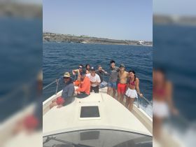 A lively group enjoys a day out on the boat, capturing the essence of summer fun and celebration on the water.