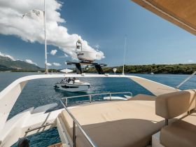 A stunning view from the deck of a yacht, showcasing another boat nearby in beautiful waters, perfect for exploring coastal destinations.