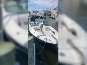 A sleek speedboat docked at the marina, showcasing its modern design and comfortable seating — perfect for a day on the water.
