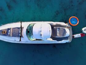 A stunning aerial view of a sleek yacht anchored in clear turquoise waters, showcasing its spacious deck and inviting amenities.