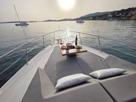 A beautifully arranged table with snacks and drinks on the deck of a yacht, perfect for enjoying a relaxing day on the water.