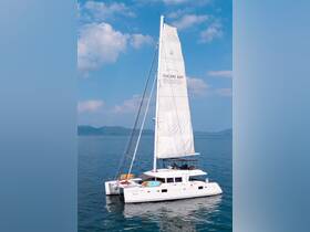 A stunning catamaran sails gracefully in the serene waters of Chalong Bay, showcasing its elegant design and perfect for a day of exploration on the water.