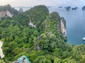 A breathtaking aerial view of lush green islands and coastline, showcasing the stunning natural beauty of the landscape — perfect for eco tours and island hopping adventures.