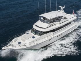 A stunning aerial view of a luxurious yacht cruising through deep blue waters, showcasing its elegant design and smooth sailing capabilities.