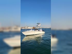 A group of individuals enjoy a day on the water aboard a boat, showcasing a lively atmosphere and the beauty of the marine environment.