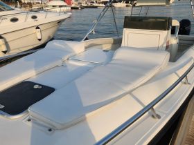 A clean and spacious interior view of a boat's seating area and helm, perfect for comfortable cruising and relaxation on the water.