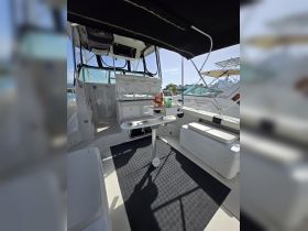 A well-equipped boat interior featuring a comfortable seating area and helm, perfect for relaxing and navigating on the water.