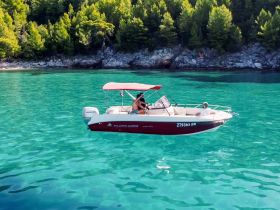 A family enjoys a day on a boat in crystal-clear waters, perfect for summer adventures and creating lasting memories.