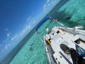 A scenic view from a boat with clear turquoise waters, showcasing snorkelers enjoying the vibrant marine life below — perfect for adventure seekers and nature lovers.