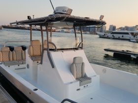 A sleek interior view of a boat's helm and seating area, showcasing modern design and comfort for an enjoyable boating experience.
