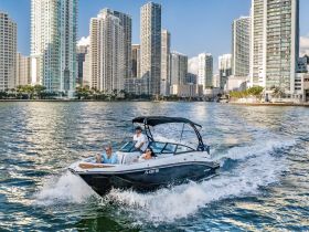 A stylish boat cruises through the vibrant cityscape, showcasing the perfect blend of urban life and water adventure.
