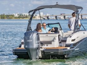 A group enjoys a day on the water aboard a sleek boat, perfect for celebrations and leisure activities. The vibrant atmosphere captures the essence of a fun-filled boating experience.